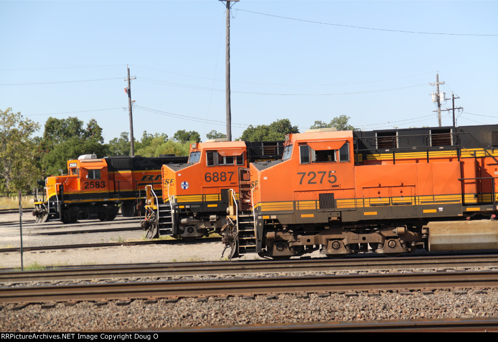 Trio of BNSF engines in Temple, Texas. Taken from depot model railroad porch. Includes an ATSF commemorative unit in center.